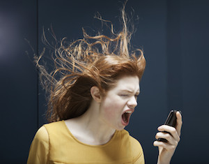 woman is shouting into phone.